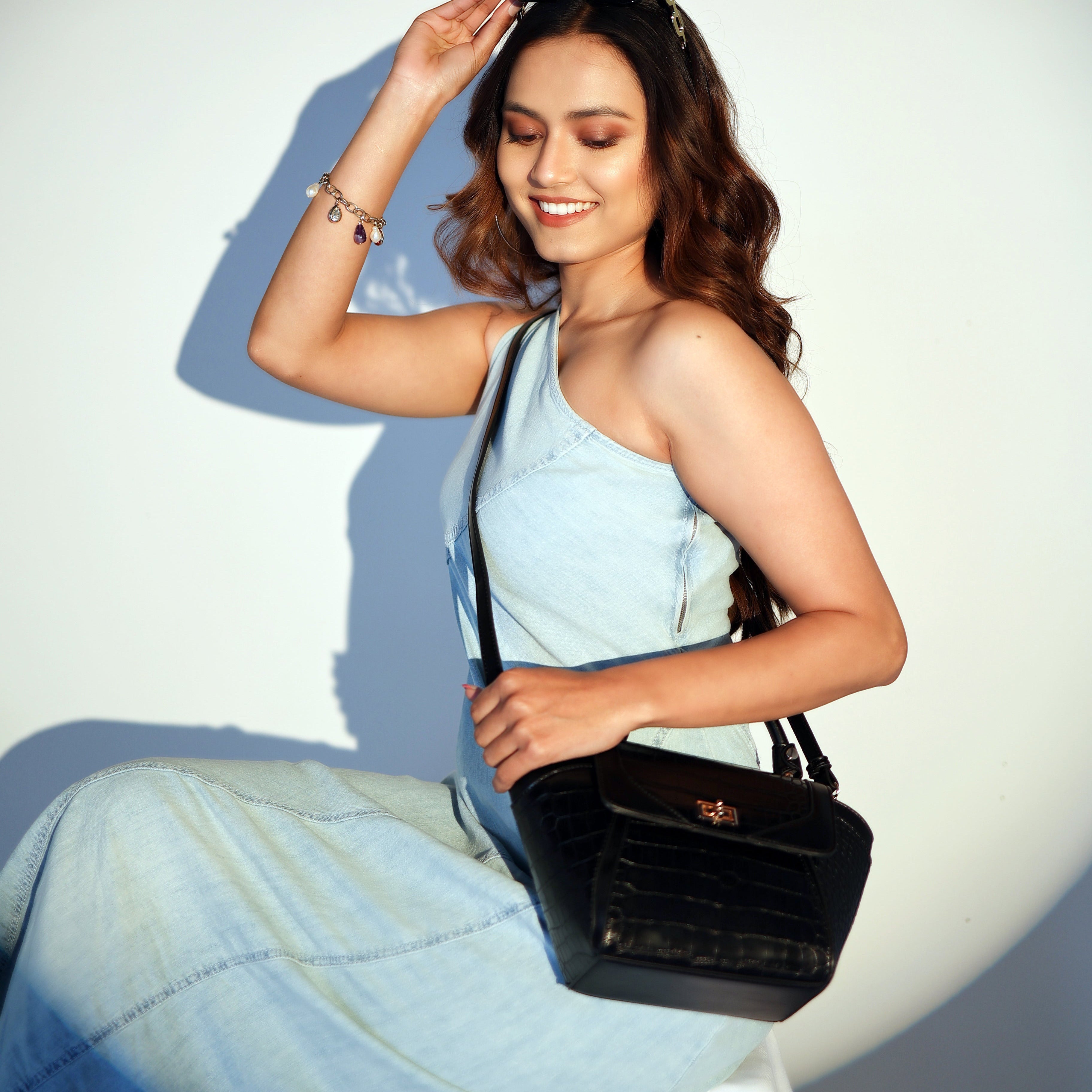 Karryol Lolita black mock-croc embossed crossbody bag with gold-tone hardware and turn-lock closure.