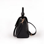 KARRYOL Lolita black mock-croc embossed crossbody bag with top handle and gold-tone hardware.