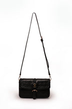KARRYOL black faux leather crossbody bag with embossed monogram panel and gold-tone buckle detail.