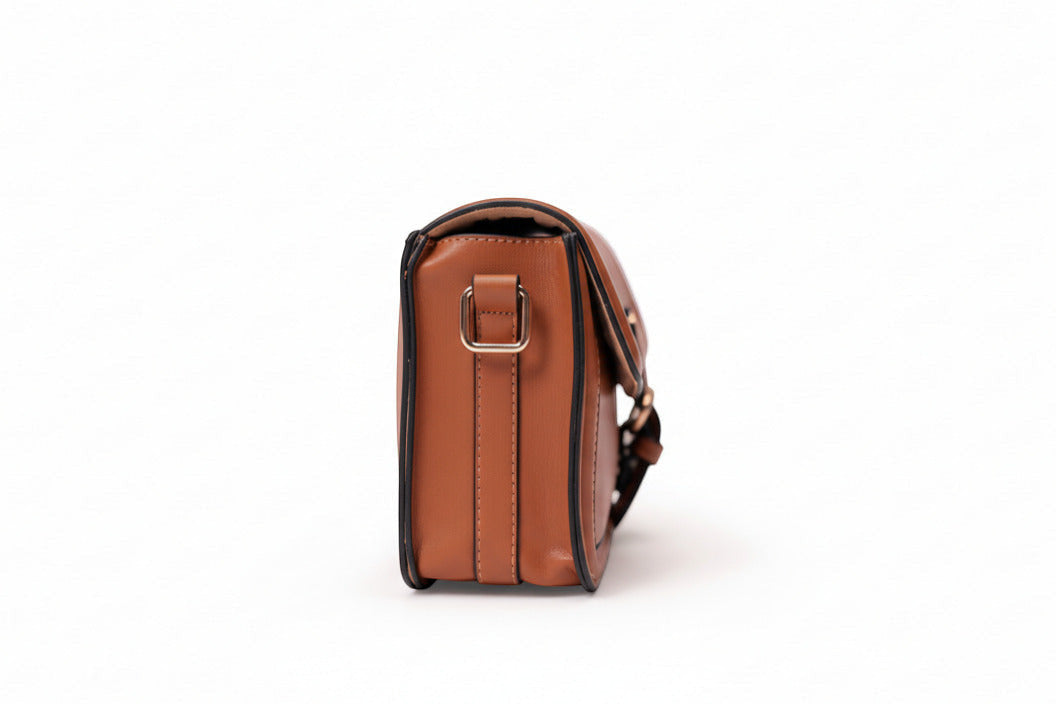 KARRYOL tan leather Kari crossbody bag with gold-tone hardware and embossed monogram panel.