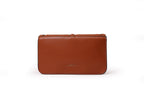 KARRYOL tan leather Kari crossbody bag with embossed monogram panel and gold-tone hardware. Structured design with adjustable strap.